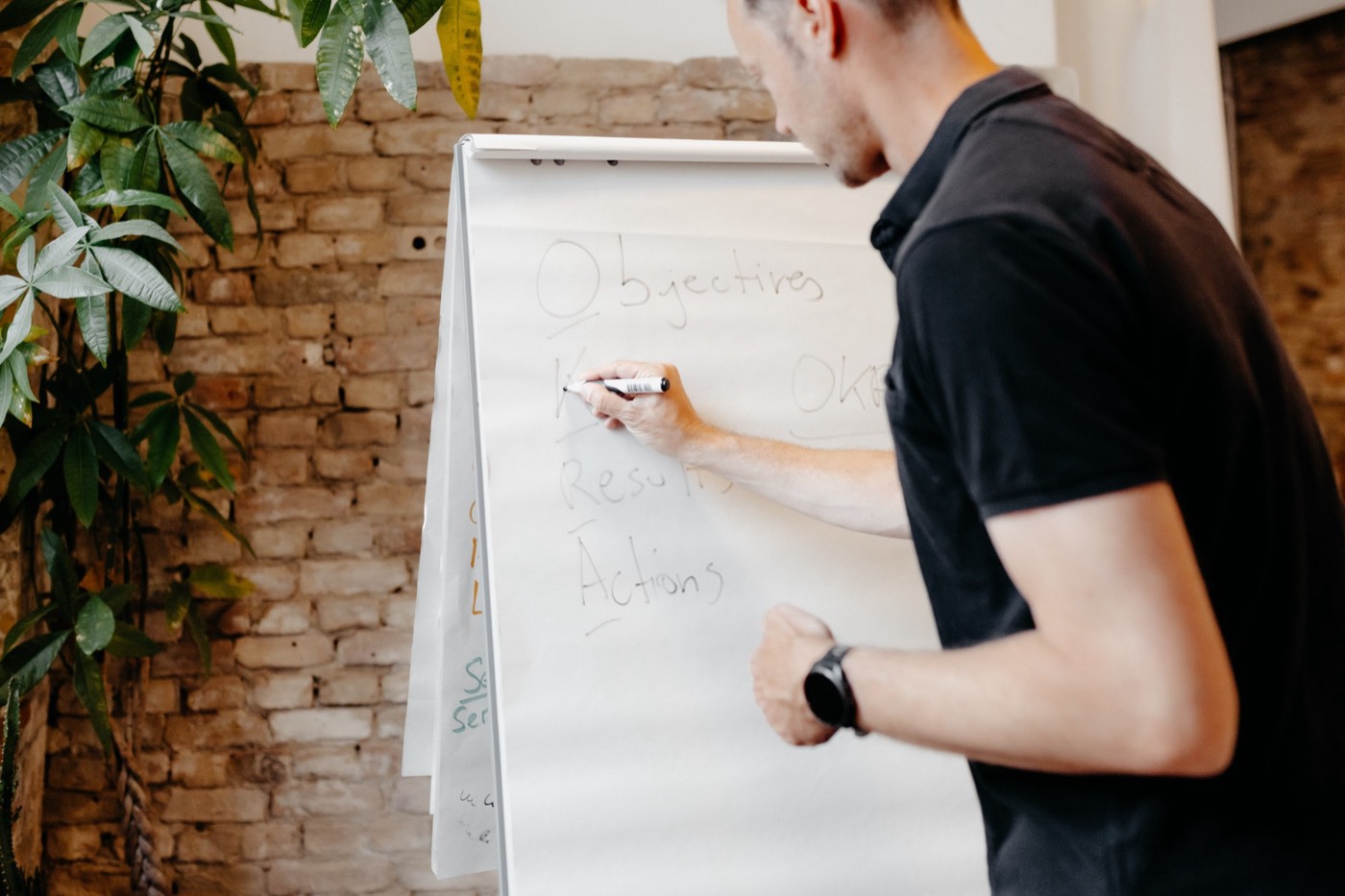 Philipp writing Objectives, Key Results and Actions on a flipchart